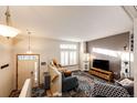 Bright living room featuring plush seating, a large window, and modern decor for comfortable living at 1461 Red Cliff Way, Castle Rock, CO 80109