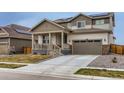 Charming two-story home with a two-car garage, solar panels, a front porch, and a well-manicured lawn at 17786 Olive St, Broomfield, CO 80023