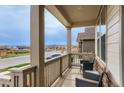 Relaxing front porch with comfortable seating, offering a scenic view of the neighborhood at 17786 Olive St, Broomfield, CO 80023