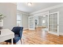 Bright office space featuring hardwood floors and French doors leading to the living room at 3647 Jason St, Denver, CO 80211