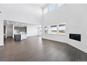 Open-concept living room with hardwood floors, modern fireplace, and easy access to kitchen at 16565 Black Rose Cir, Parker, CO 80134