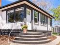 Inviting front porch with a decorative flower pot and concrete steps to the front door at 2517 W 44Th Ave, Denver, CO 80211