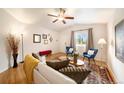Bright living room features hardwood floors, large windows, and comfortable seating with a stylish rug at 124 3Rd St, Fort Lupton, CO 80621