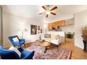 Bright living room featuring hardwood floors, large windows, and access to the kitchen and dining area at 124 3Rd St, Fort Lupton, CO 80621