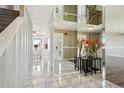 Bright entryway with marble flooring, mirrored walls, and views of the living spaces at 8732 W Arbor Ave, Littleton, CO 80123