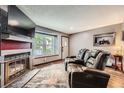 Comfortable living room with fireplace, and luxury recliners offer a perfect space to relax at 9672 W Chatfield Ave # C, Littleton, CO 80128