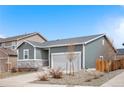 Single-Gathering home with a two-car garage, set against a clear blue sky at 114 S Edge Cliff St, Castle Rock, CO 80104