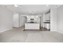 Bright, open-concept living space with a view of the kitchen at 114 S Edge Cliff St, Castle Rock, CO 80104