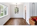 Bright dining room boasts hardwood floors and plenty of natural light from large windows at 1213 Jamaica St, Aurora, CO 80010