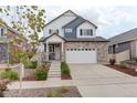 Charming two-story home with a stone facade, attached garage, and landscaped front yard at 4444 N Picadilly Ct, Aurora, CO 80019