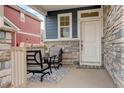 Inviting front porch featuring a cozy seating area with chairs, a table, and decorative rug for relaxing outdoors at 4444 N Picadilly Ct, Aurora, CO 80019