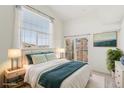 Airy primary bedroom featuring a large window, calming decor, and ample natural light at 1495 Blue Sky Way # 9-308, Erie, CO 80516