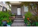 Beautifully landscaped front entrance with stone steps, colorful flowers, and a well-maintained lawn at 8774 Martin Luther King Blvd, Denver, CO 80238