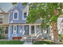 Attractive townhome with inviting entrance, enhanced by mature trees providing shade and curb appeal at 9771 W Cornell Pl, Lakewood, CO 80227