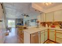 Cozy kitchen with tiled ceiling, open to living area with fireplace and natural light at 9771 W Cornell Pl, Lakewood, CO 80227