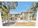 Rear exterior view showing a multi-level deck and access to the home at 30633 Kings Valley Dr, Conifer, CO 80433