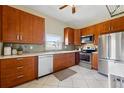 Well-lit kitchen with stainless steel appliances, tiled backsplash, and ample cabinet space at 1001 E 17Th Ave # 12, Denver, CO 80218
