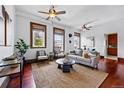 Inviting living room features hardwood floors, plenty of natural light, and ceiling fans at 1001 E 17Th Ave # 12, Denver, CO 80218