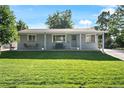 Beautiful single-story home with a lush green lawn and inviting front porch at 6800 S Pennsylvania St, Centennial, CO 80122