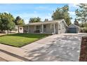 Charming home with a well-maintained lawn, a detached garage and inviting curb appeal at 6800 S Pennsylvania St, Centennial, CO 80122