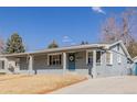 Single-story home features a welcoming front porch and a well-manicured lawn at 6800 S Pennsylvania St, Centennial, CO 80122