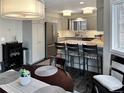 Bright kitchen and dining area features stainless steel appliances, bar seating, and modern lighting at 290 Broken Lance Dr # B104, Breckenridge, CO 80424