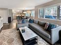 Open floor plan with views of kitchen, dining area, and comfortable living room with L-shaped couch at 290 Broken Lance Dr # B104, Breckenridge, CO 80424