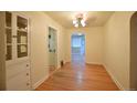 Bright dining area featuring hardwood floors, a built in, and a view into other rooms at 1409 S Clermont St, Denver, CO 80222