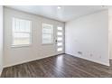 Bright entryway with wood floors, white walls, and modern front door with natural light at 21761 E 7Th Ave, Aurora, CO 80018