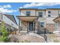 Charming townhouse featuring stone accents, a covered porch, and inviting curb appeal at 21761 E 7Th Ave, Aurora, CO 80018