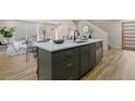 Open-concept kitchen featuring a large island with modern fixtures and adjacent living space at 3711 Pecos St, Denver, CO 80211