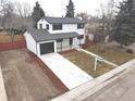 Newly renovated two-story house with a spacious driveway and well-maintained lawn at 6148 Nelson St, Arvada, CO 80004