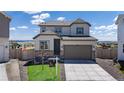 Beautiful two-story home with a two-car garage, manicured lawn, and neutral color palette at 13446 Amber Sky St, Parker, CO 80134