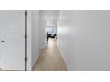 Bright hallway features wood floors and white doors, leading to a naturally lit living space at 13446 Amber Sky St, Parker, CO 80134