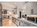 Modern kitchen with white cabinetry, stainless steel appliances, and a spacious countertop at 519 S Gaylord St, Denver, CO 80209