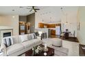 Bright open-concept living area showcasing stylish furnishings, fireplace, and seamless flow to the modern kitchen and dining space at 3250 E 103Rd Pl # 805, Thornton, CO 80229