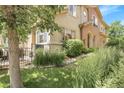 This home features a well-maintained lawn, patio, and beautiful architectural details at 10152 Bluffmont Ln, Lone Tree, CO 80124