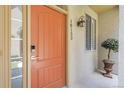 Inviting front entrance with a vibrant door, stylish lighting, and manicured greenery at 10152 Bluffmont Ln, Lone Tree, CO 80124