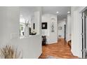 Bright foyer with hardwood floors and elegant decor leading to the main living areas at 10152 Bluffmont Ln, Lone Tree, CO 80124
