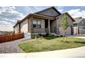 Inviting home exterior with a covered porch, tasteful landscaping and an attached two car garage at 4090 Forever Cir, Castle Rock, CO 80109