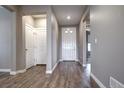 Elegant foyer with hardwood floors, white trim, and neutral gray walls, leading to other rooms at 4090 Forever Cir, Castle Rock, CO 80109