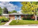 Inviting single-story home with lush green lawn and mature trees at 7005 S Ash Cir, Centennial, CO 80122