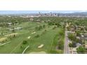 Breathtaking aerial view of a lush golf course with the city skyline in the distance at 2945 E 26Th Avenue Pkwy, Denver, CO 80205