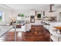 Bright, open-concept living room and kitchen area with stainless steel appliances and hardwood floors at 2945 E 26Th Avenue Pkwy, Denver, CO 80205