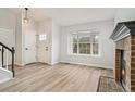 Bright entryway with hardwood floors and a view into the living room at 8362 White Cloud St, Highlands Ranch, CO 80126