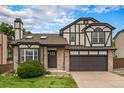 Two-story house with a dark brown garage door and landscaped yard at 8362 White Cloud St, Highlands Ranch, CO 80126