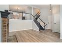 Living room with fireplace, staircase, and hardwood floors at 8362 White Cloud St, Highlands Ranch, CO 80126