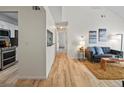 Open-concept living room with wood floors, neutral paint, and access to the kitchen at 7379 S Gore Range Rd # 304, Littleton, CO 80127