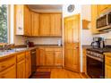 Kitchen showcasing wood cabinets, stainless appliances, and hardwood floors at 6752 S Columbine Rd, Evergreen, CO 80439