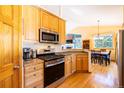 Kitchen featuring wooden cabinets, stainless steel appliances, and an adjacent dining area at 6752 S Columbine Rd, Evergreen, CO 80439
